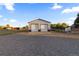 Detached garage with double doors and a gravel driveway at 9941 Ammons Cir, Broomfield, CO 80021