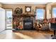Stone fireplace with built-in shelving and autumnal decor at 9941 Ammons Cir, Broomfield, CO 80021