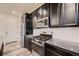Modern kitchen with dark cabinets, granite countertops, and stainless steel appliances at 9307 Inca Dove Cir, Littleton, CO 80125