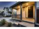 Inviting front porch with dark door and gray steps at 9307 Inca Dove Cir, Littleton, CO 80125