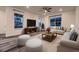 Living room with hardwood floors, large windows and staged furniture at 9307 Inca Dove Cir, Littleton, CO 80125