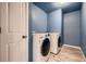 Convenient laundry room with LG washer and dryer, and blue walls at 9307 Inca Dove Cir, Littleton, CO 80125