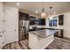 Modern kitchen with dark cabinets, granite counters, and stainless steel appliances at 9307 Inca Dove Cir, Littleton, CO 80125