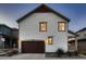 Two-story house with dark brown garage door and light-colored siding at 9307 Inca Dove Cir, Littleton, CO 80125