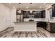 Modern kitchen with dark cabinets, granite counters, and stainless steel appliances at 9307 Inca Dove Cir, Littleton, CO 80125