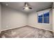 Light grey bedroom with ceiling fan and window at 9307 Inca Dove Cir, Littleton, CO 80125