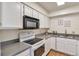 Bright kitchen with white cabinets and gray countertops at 1850 Folsom St # 411, Boulder, CO 80302