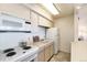 Small kitchen with white appliances and light-colored cabinetry at 1020 15Th St # 25F, Denver, CO 80202