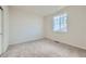 Bright bedroom with neutral carpeting and a window at 1397 Brookfield Pl, Erie, CO 80026