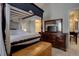 Main bedroom with a large dresser and views into another room at 6945 S Dover Way, Littleton, CO 80128