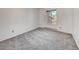Simple bedroom with gray carpeting and a window with natural light at 14751 E Tennessee Dr # 225, Aurora, CO 80012