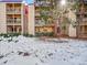 Building exterior with balconies and snow at 14751 E Tennessee Dr # 225, Aurora, CO 80012