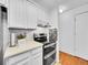 Modern kitchen with stainless steel appliances and a tile backsplash at 14751 E Tennessee Dr # 225, Aurora, CO 80012