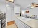 Kitchen with double sink, light beige countertops, and white cabinets at 14751 E Tennessee Dr # 225, Aurora, CO 80012