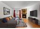 Bright living room with fireplace, hardwood floors, and access to a balcony at 14751 E Tennessee Dr # 225, Aurora, CO 80012