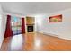 Living room with fireplace, hardwood floors, and balcony access at 14751 E Tennessee Dr # 225, Aurora, CO 80012