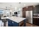 Modern kitchen with stainless steel appliances and a large island at 10065 Town Ridge Ln, Lone Tree, CO 80124