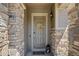 Front entry with stone pillars and a wreath at 15004 W 63Rd Ave, Arvada, CO 80403