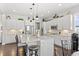 Modern kitchen with white cabinets, stainless steel appliances, and an island at 15004 W 63Rd Ave, Arvada, CO 80403