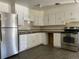 Classic kitchen with white cabinets and stainless steel appliances at 2696 S Jersey St, Denver, CO 80222