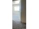 Open door to a bright carpeted bedroom with a window at 2696 S Jersey St, Denver, CO 80222