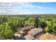 Aerial view of house and surrounding neighborhood with mountain views at 1250 Oneida St, Denver, CO 80220