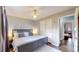 Main bedroom with king bed, ceiling fan, and access to another room at 28 W Broadmoor Dr, Littleton, CO 80120