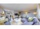 Open living room with hardwood floors, gray sectional and kitchen peek at 28 W Broadmoor Dr, Littleton, CO 80120
