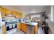 Updated kitchen with stainless steel appliances and wood cabinets at 28 W Broadmoor Dr, Littleton, CO 80120