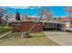 Brick ranch home with attached carport and mature tree in front at 28 W Broadmoor Dr, Littleton, CO 80120