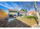 View of backyard with patio, grill, and partially fenced yard at 3670 Pontiac St, Denver, CO 80207