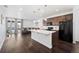 Modern kitchen featuring a large island and dark wood cabinets at 9963 Truckee St, Commerce City, CO 80022