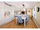 Bright dining room with white table and blue patterned chairs, open to the kitchen at 7107 E Costilla Dr, Centennial, CO 80112