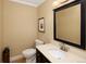 Powder room with dark vanity, a framed mirror and light beige walls at 7107 E Costilla Dr, Centennial, CO 80112