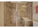Modern bathroom with tiled shower, glass door, and built-in seat at 1488 Madison St # 211, Denver, CO 80206