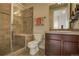 Bathroom with walk-in shower, tiled walls, single vanity, and modern fixtures at 1488 Madison St # 211, Denver, CO 80206