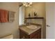 Modern bathroom with tiled countertop, single vanity, and decorative shelf at 1488 Madison St # 211, Denver, CO 80206