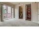 Bedroom with carpeted floors, balcony access, and ensuite bathroom and laundry at 1488 Madison St # 211, Denver, CO 80206