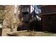 Side view of a brick building with balconies and trees at 1488 Madison St # 211, Denver, CO 80206