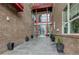 Building exterior with brick walls, red accents, and glass entryway at 1488 Madison St # 211, Denver, CO 80206