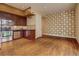 Open-concept kitchen and living area with wood flooring and decorative wall at 1488 Madison St # 211, Denver, CO 80206