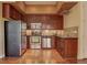 Well-appointed kitchen with stainless steel appliances, wood cabinets, and ample storage at 1488 Madison St # 211, Denver, CO 80206