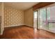 Spacious living room with hardwood floors, decorative wall, and balcony access at 1488 Madison St # 211, Denver, CO 80206