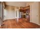 Living room and kitchen area with wood floors, stainless steel appliances, and balcony access at 1488 Madison St # 211, Denver, CO 80206