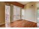 Living room with wood floors, large windows, and a sliding glass door leading to a balcony at 1488 Madison St # 211, Denver, CO 80206