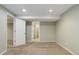 Bright, finished basement area with neutral walls and carpeting at 12388 E Caspian Dr, Aurora, CO 80014