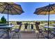 Deck with seating and umbrellas, overlooking a neighborhood at 1743 Brookside Dr, Highlands Ranch, CO 80126