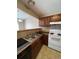 Kitchen with dark wood cabinets and white appliances at 19973 E Dartmouth Ave, Aurora, CO 80013