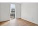 Simple bedroom with hardwood floors and window with city view at 3575 Chestnut Pl # 601, Denver, CO 80216