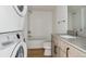 Clean bathroom with white tiled walls, bathtub, and modern vanity at 3575 Chestnut Pl # 601, Denver, CO 80216